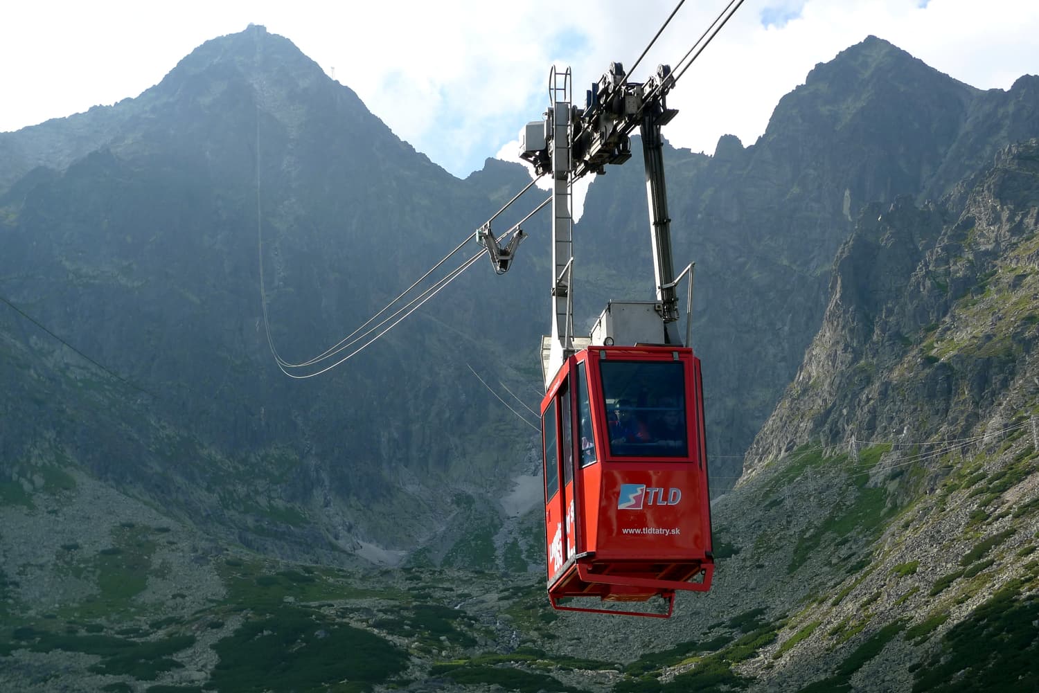 The red cable car to Lomnický štít hanging above a rocky cirque
