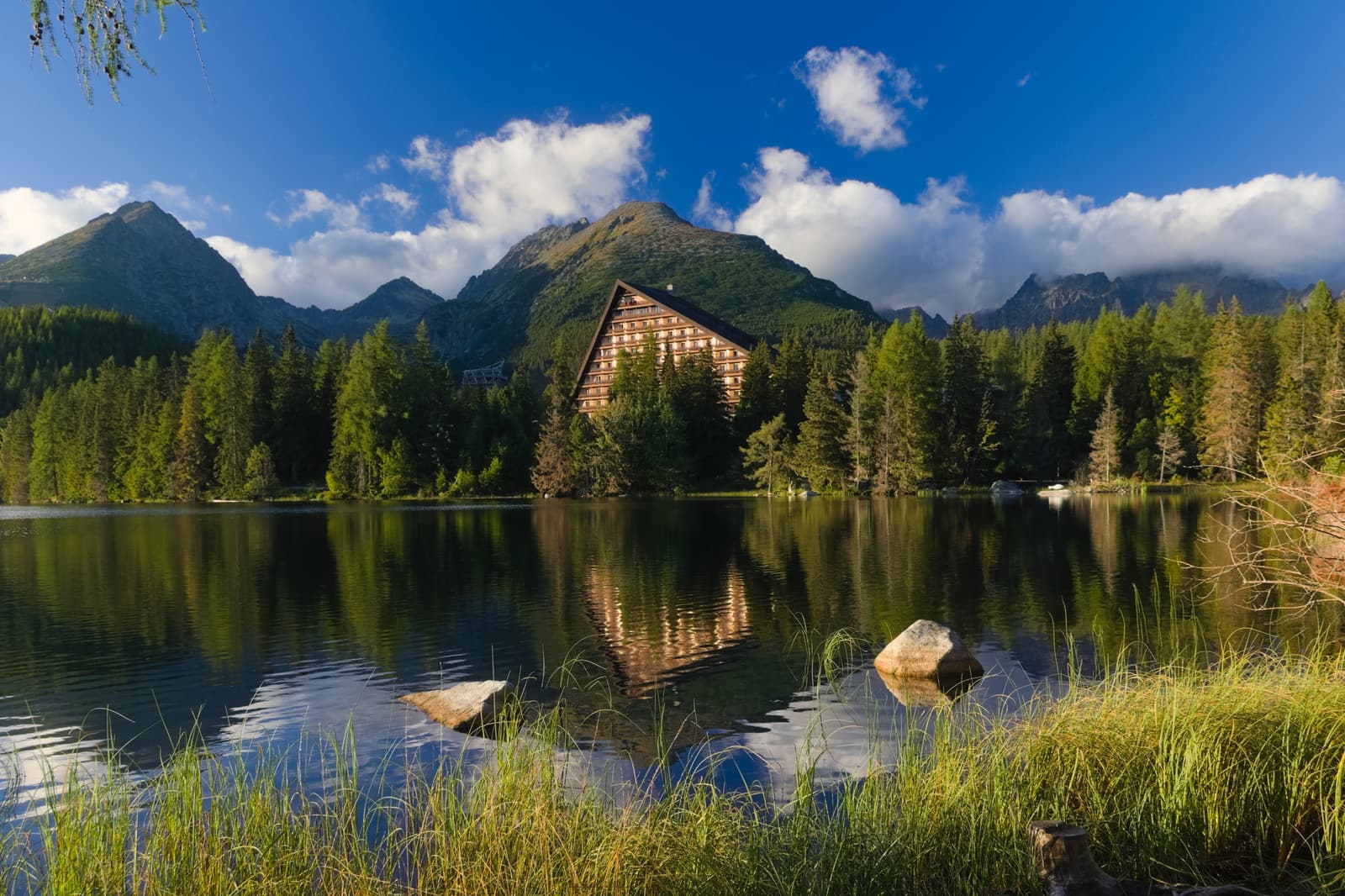 Hotel Patria and the forested shore of Štrbské pleso below the Tatra peaks